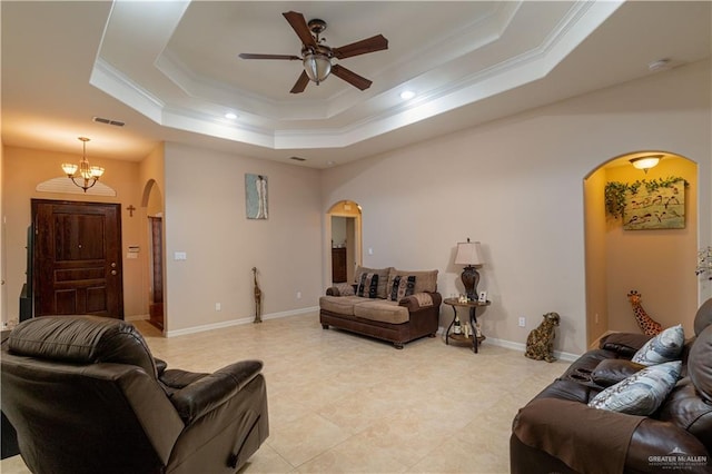1014 Emerald Dr, Weslaco, TX 78599 - living area featuring arched walkways, a tray ceiling, crown molding, a ceiling fan, and light tile patterned floors