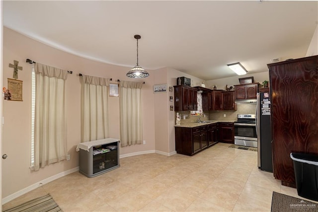 1014 Emerald Dr, Weslaco, TX 78599 - kitchen featuring appliances with stainless steel finishes, a sink, dark brown cabinets, tasteful backsplash, and under cabinet range hood