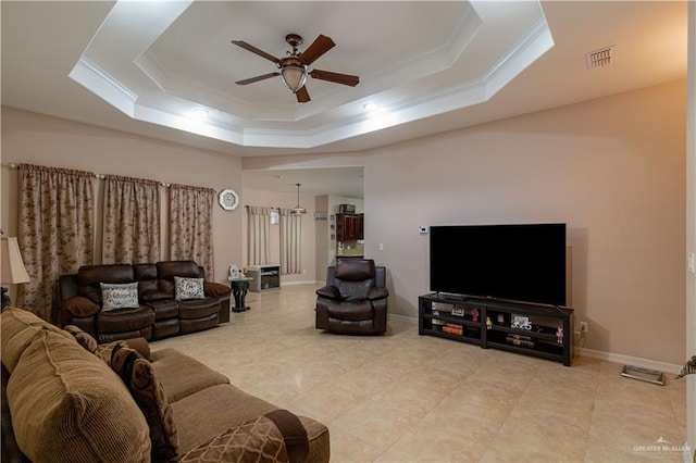 1014 Emerald Dr, Weslaco, TX 78599 - living area featuring a tray ceiling, ceiling fan, crown molding, light tile patterned flooring, and baseboards