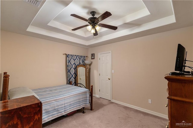 1014 Emerald Dr, Weslaco, TX 78599 - carpeted bedroom featuring a raised ceiling, baseboards, and ceiling fan