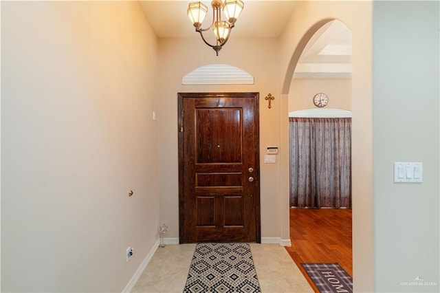 1014 Emerald Dr, Weslaco, TX 78599 - entryway with a chandelier, baseboards, and arched walkways