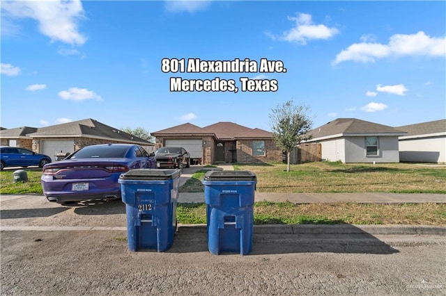 ranch-style house featuring a garage and a front yard