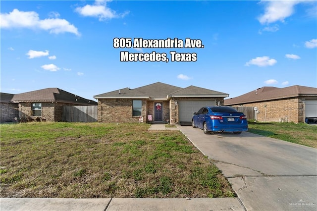 view of front of property featuring a garage and a front yard