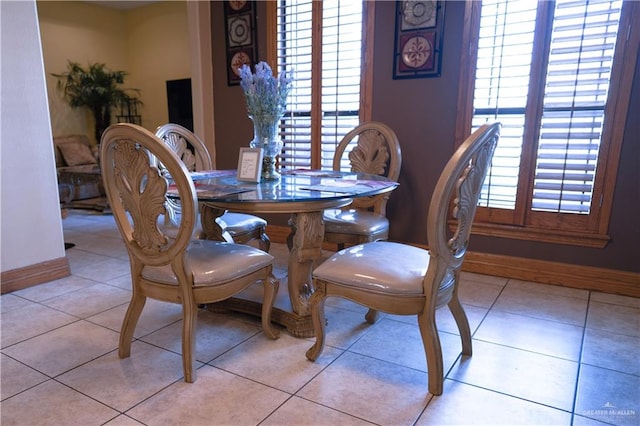 dining area with light tile patterned floors and plenty of natural light