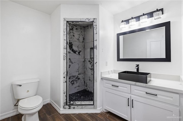 bathroom featuring an enclosed shower, vanity, and toilet