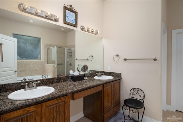 bathroom with vanity and shower with separate bathtub