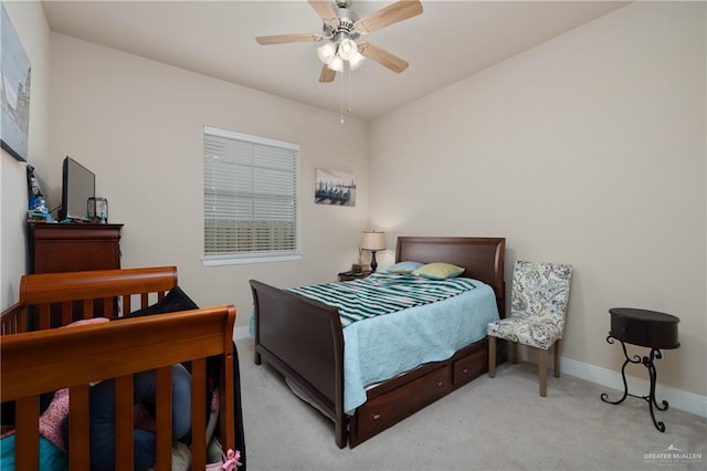 bedroom with ceiling fan and light colored carpet