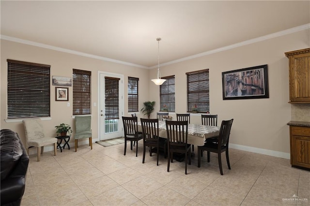 dining space featuring crown molding and light tile patterned floors