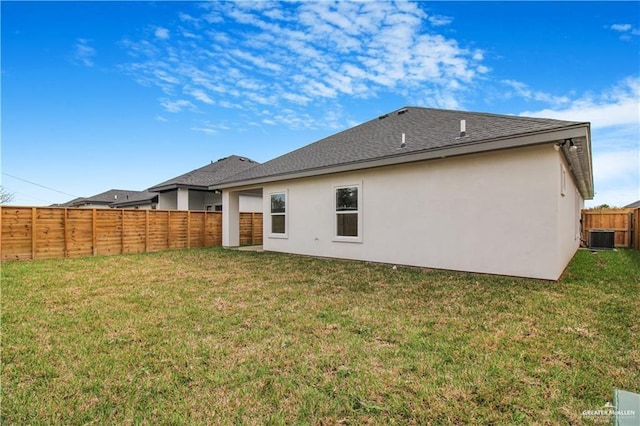 back of property with a lawn, a fenced backyard, roof with shingles, cooling unit, and stucco siding