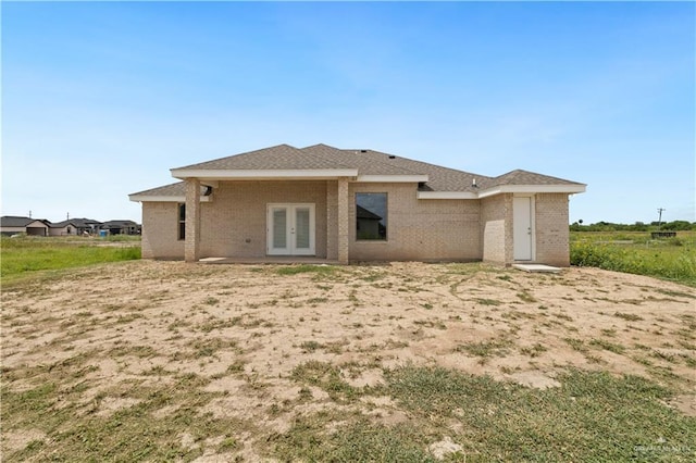 907 39th St, San Juan, TX 78516 - back of property with french doors and brick siding