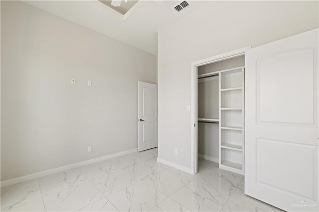 907 39th St, San Juan, TX 78516 - unfurnished bedroom featuring light marble finish floors, a closet, and a walk in closet