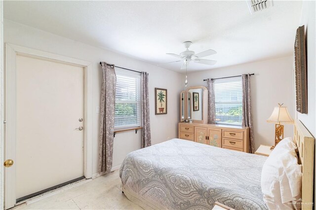 bedroom featuring ceiling fan and multiple windows