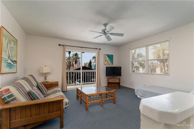 carpeted living room featuring ceiling fan and a healthy amount of sunlight