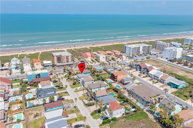 bird's eye view featuring a water view and a beach view