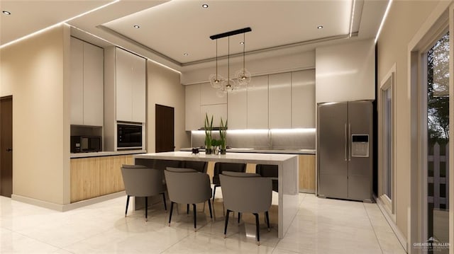 kitchen with modern cabinets, a towering ceiling, tasteful backsplash, black microwave, and stainless steel refrigerator with ice dispenser