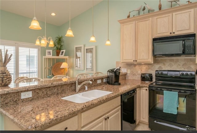 kitchen featuring sink, light stone counters, a notable chandelier, pendant lighting, and black appliances