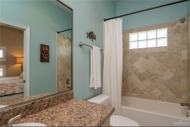 full bathroom featuring shower / bath combination with curtain, vanity, and toilet