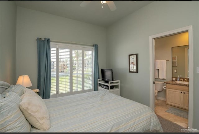 carpeted bedroom featuring connected bathroom, ceiling fan, and sink