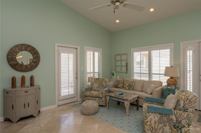 living room with light tile patterned floors, vaulted ceiling, ceiling fan, and a healthy amount of sunlight