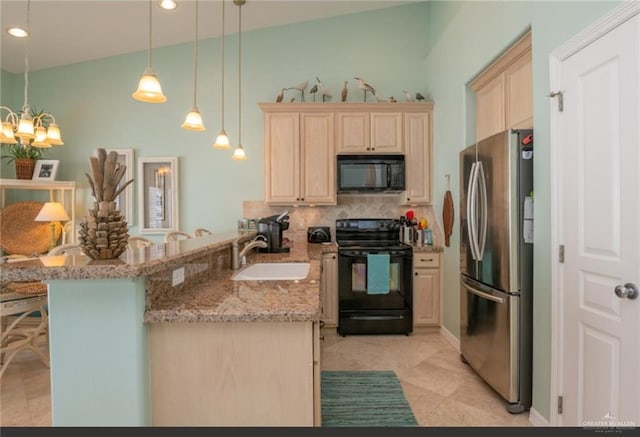 kitchen featuring black appliances, hanging light fixtures, vaulted ceiling, light stone countertops, and kitchen peninsula