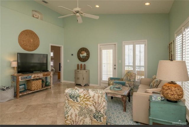 living room featuring ceiling fan and high vaulted ceiling