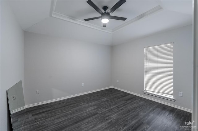 spare room featuring ceiling fan, dark hardwood / wood-style flooring, ornamental molding, and a tray ceiling