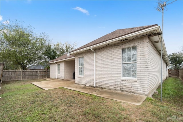 rear view of property with a patio area and a yard