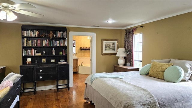 bedroom featuring ceiling fan, connected bathroom, hardwood / wood-style flooring, and crown molding