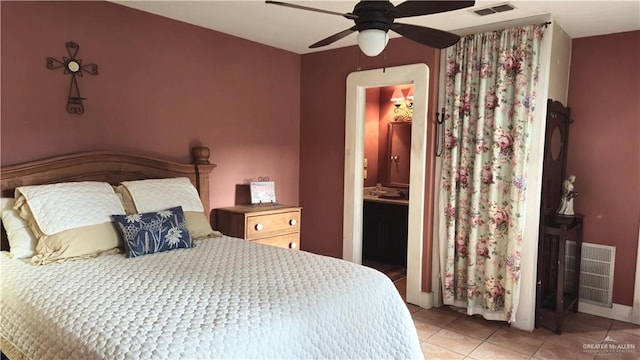 tiled bedroom with ensuite bathroom and ceiling fan