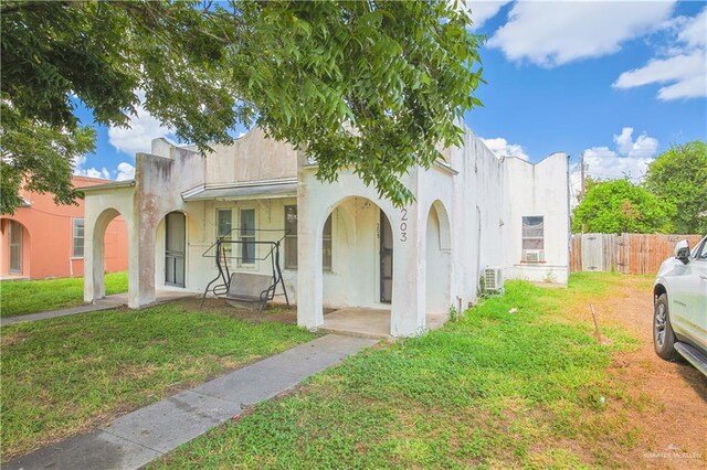 mediterranean / spanish house with a front lawn