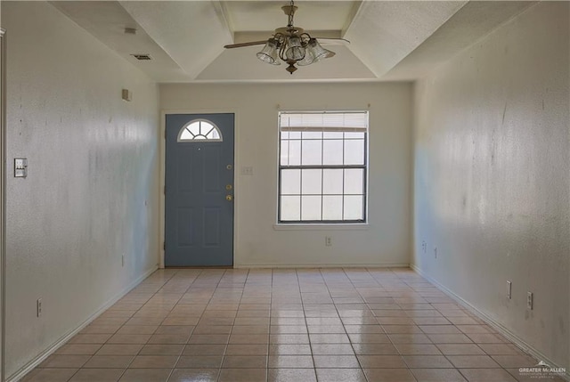 entryway with ceiling fan, light tile patterned floors, and lofted ceiling