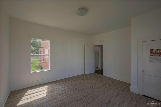 spare room with hardwood / wood-style floors