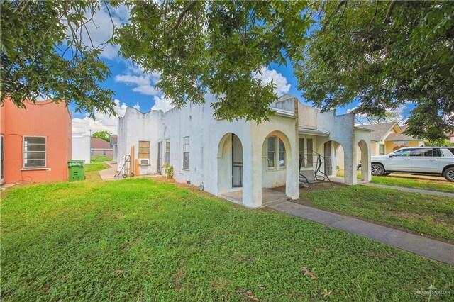 mediterranean / spanish-style house with a front yard