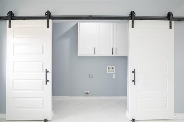 clothes washing area with washer hookup, cabinets, and hookup for an electric dryer