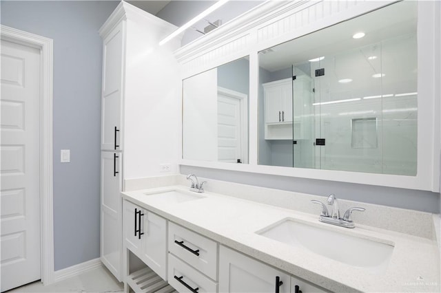 bathroom featuring a shower with door and vanity