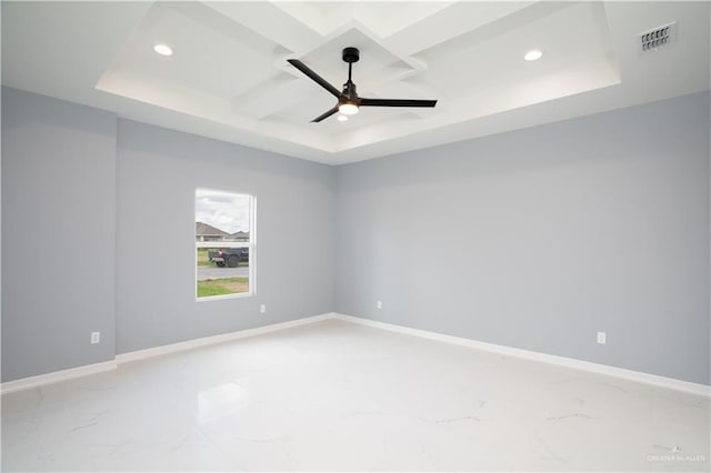 spare room featuring ceiling fan, a raised ceiling, and coffered ceiling