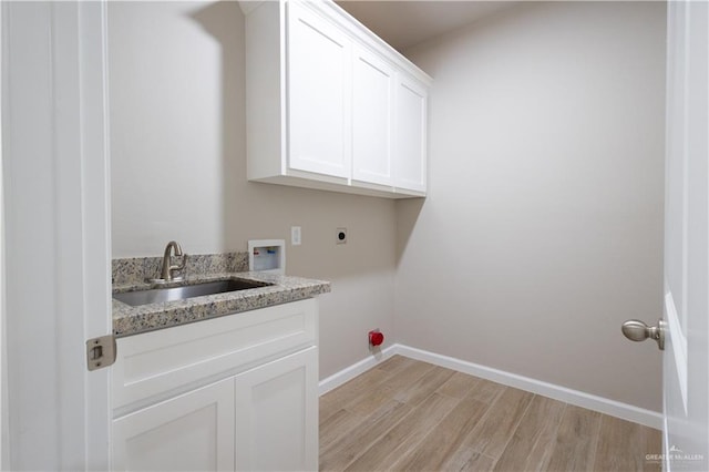 2908 Ibiza Ct, Mission, TX 78572 - laundry room featuring hookup for an electric dryer, cabinet space, hookup for a washing machine, light wood-style flooring, and baseboards
