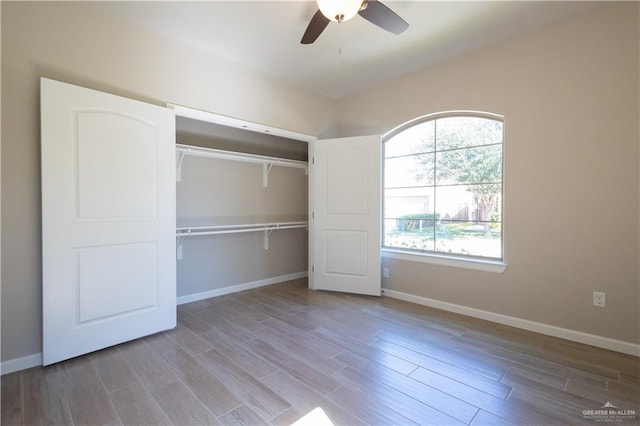 unfurnished bedroom with ceiling fan, a closet, and light wood-type flooring