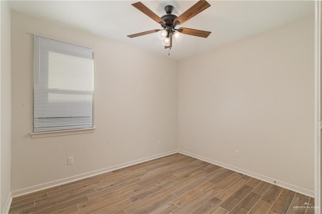 unfurnished room featuring ceiling fan, baseboards, and wood finished floors