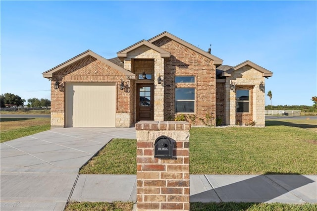 view of front of home with a garage and a front lawn