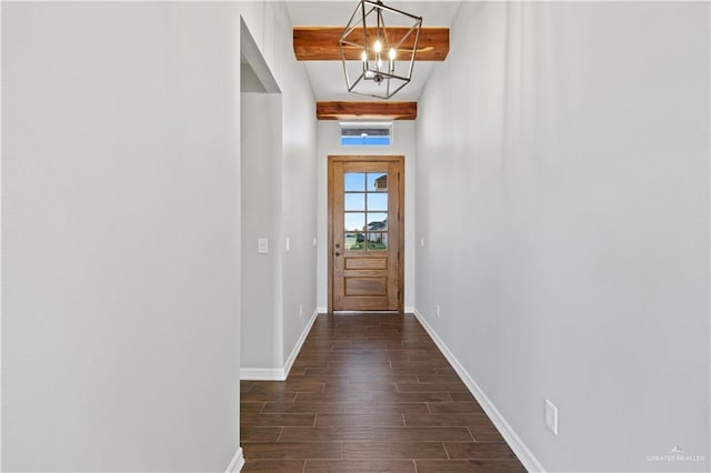 entryway with beamed ceiling, dark hardwood / wood-style flooring, and a notable chandelier