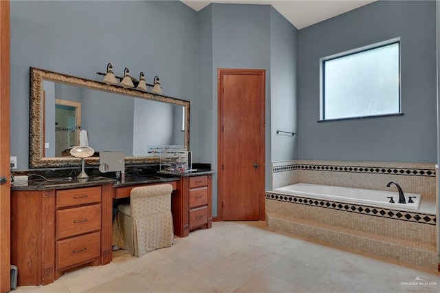 bathroom featuring vanity and tiled bath