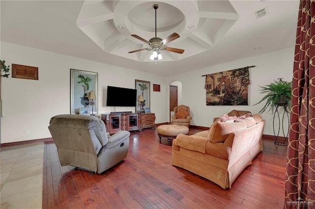 living room featuring wood-type flooring, ceiling fan, and coffered ceiling