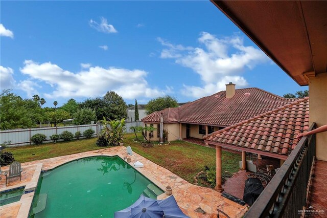 view of pool with a yard and a patio