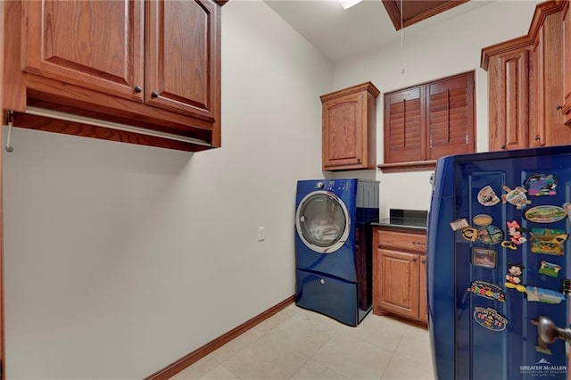 laundry room featuring cabinets and washer / clothes dryer