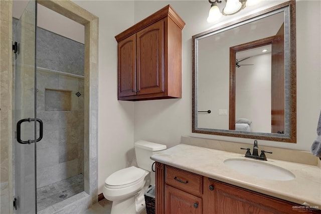 bathroom featuring vanity, toilet, and walk in shower