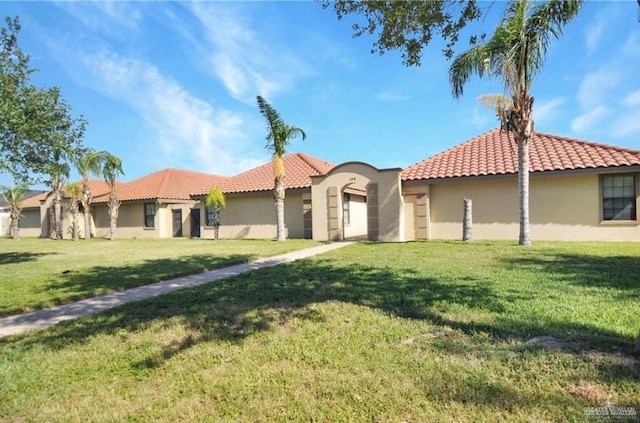 mediterranean / spanish-style house featuring a front yard