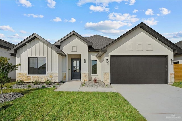 view of front of house with concrete driveway, board and batten siding, a garage, stone siding, and a front lawn