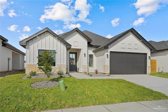 view of front of property featuring an attached garage, a front yard, board and batten siding, and concrete driveway