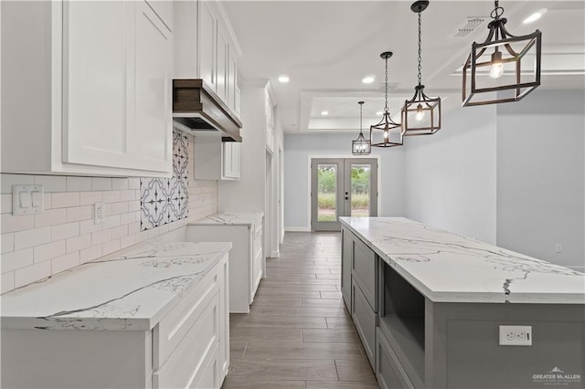 kitchen featuring white cabinets and decorative light fixtures